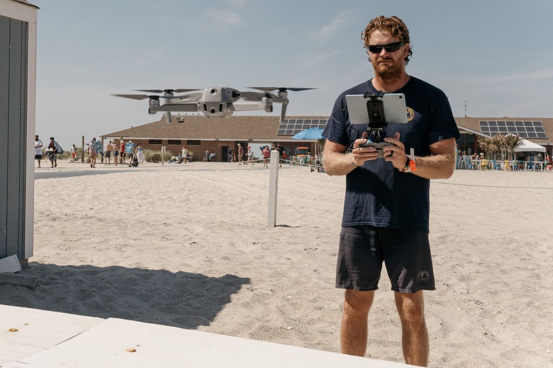 Colin Hickey, a lifeguard on Jones Beach, mans a drone to scan the waters for signs of sharks.